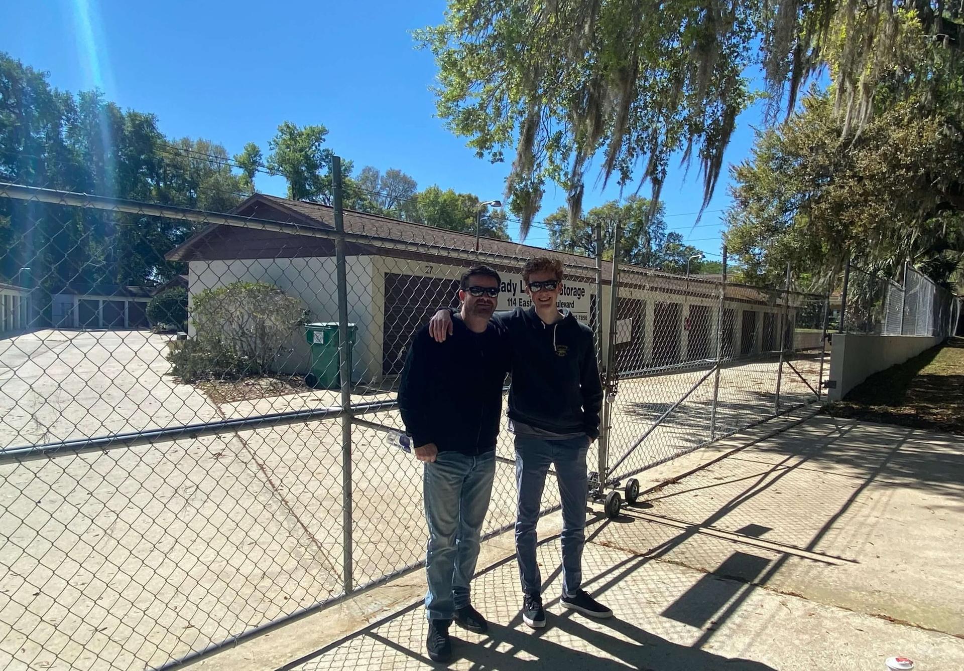 Hunter and his Dad in front of his first facility