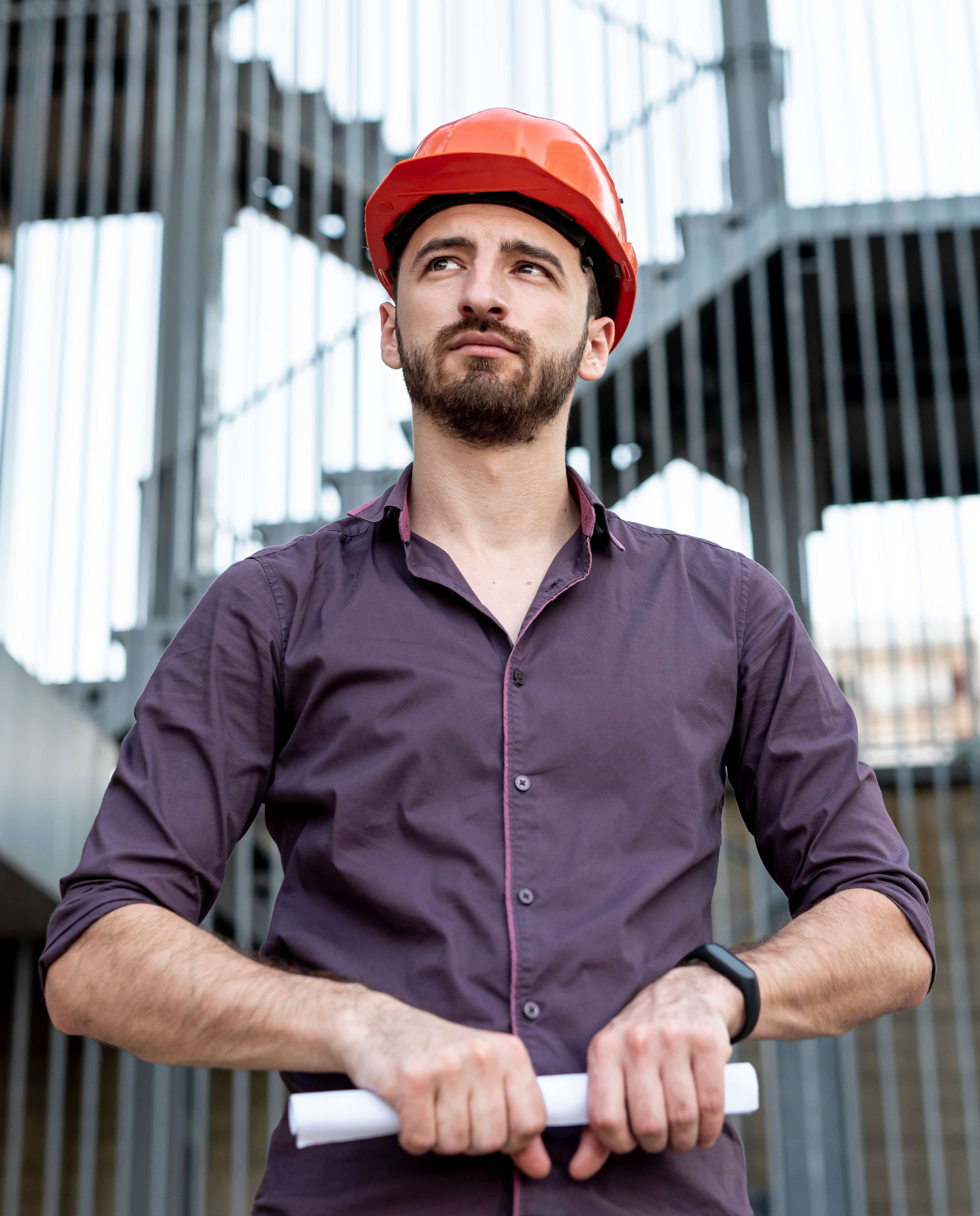 Storage facility owner and general contractor holding blueprints at construction site - cost to build storage units case study